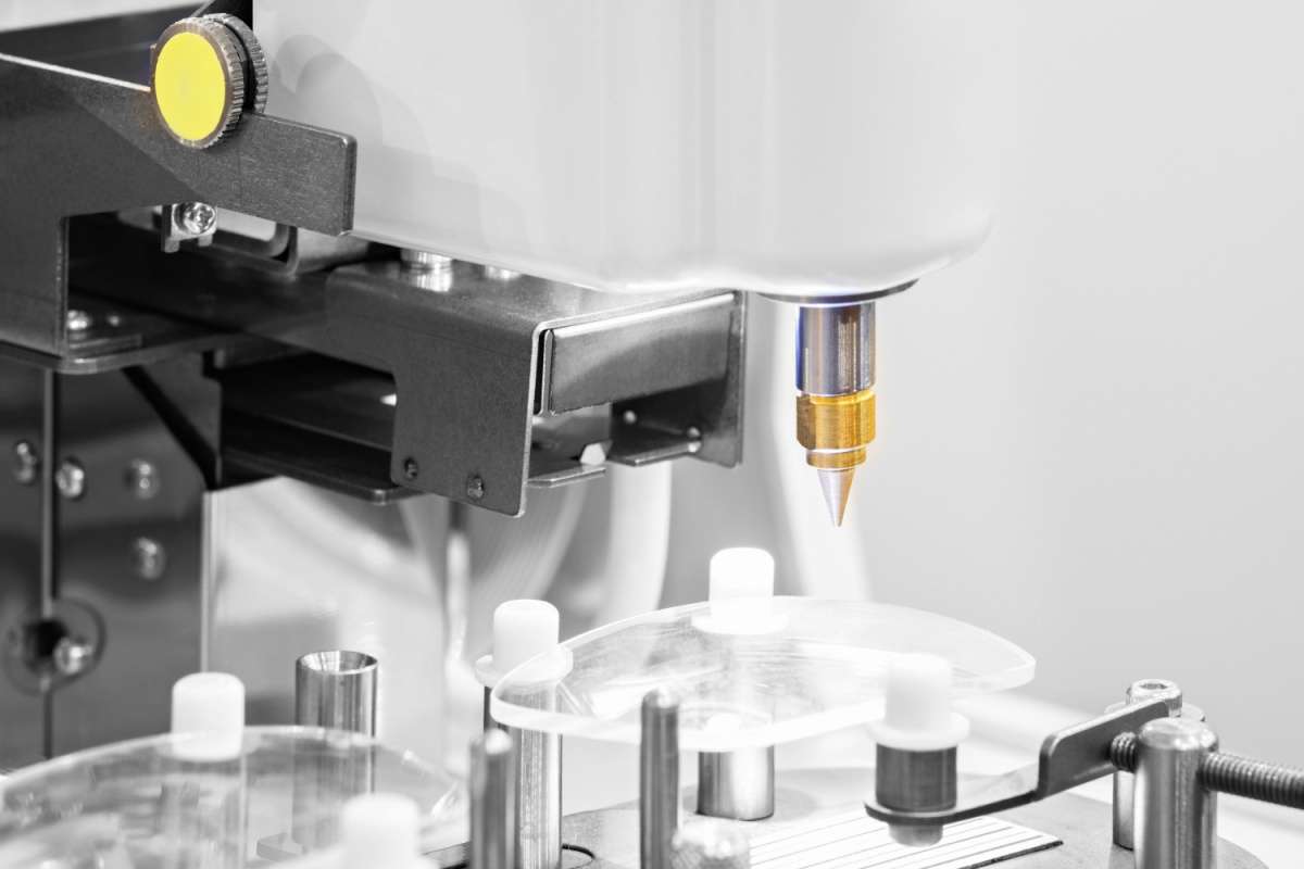 Close-up of an optical lens cutting machine used in an in-house lab to shape and finish eyeglass lenses with precision.